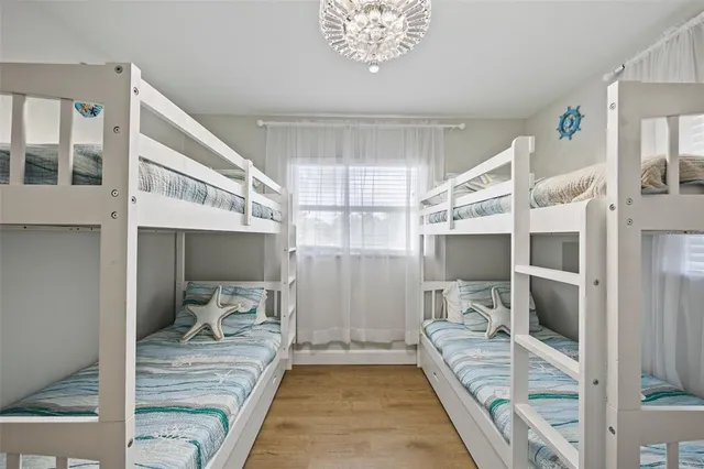 a room with a bed and glass door