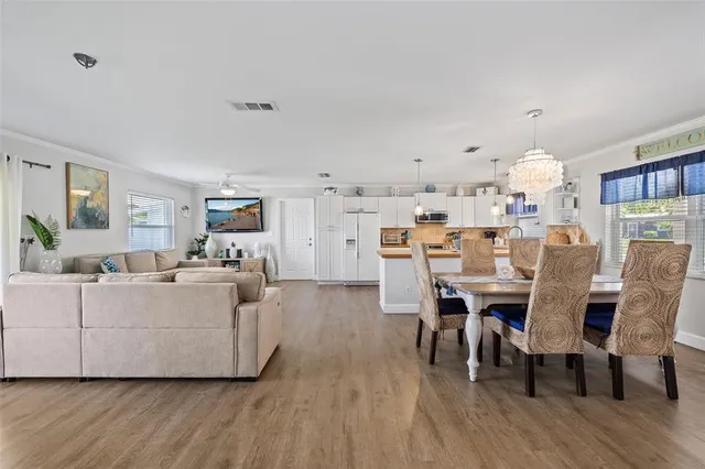a living room with lots of furniture and kitchen view