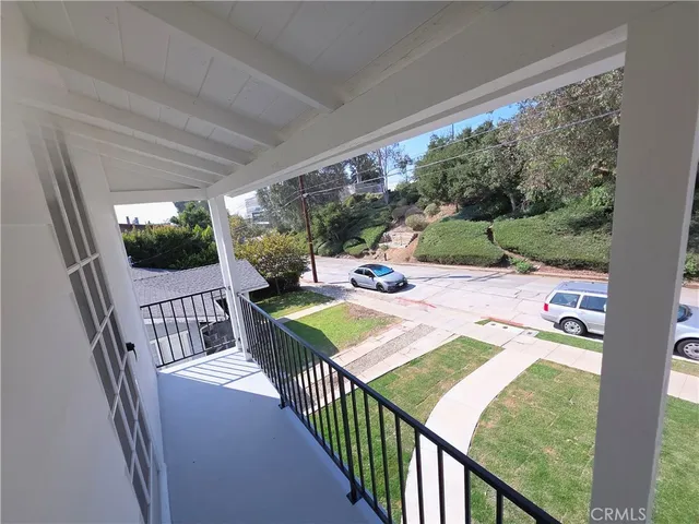 a view of a patio with a table chairs and a backyard
