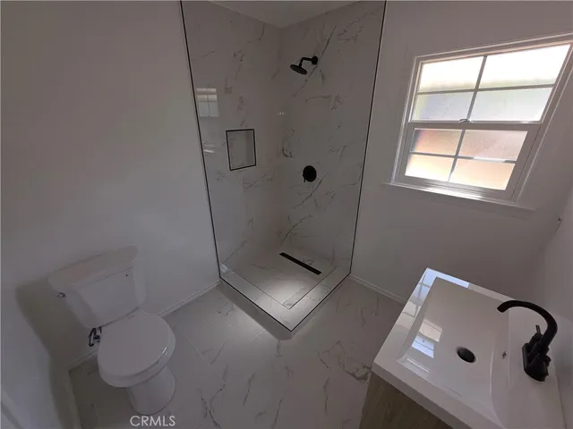 a bathroom with a toilet and a shower