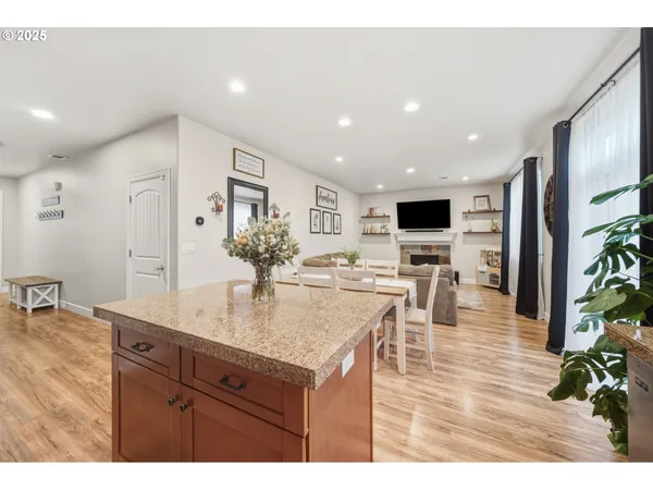 a view of living room kitchen with furniture and wooden floor