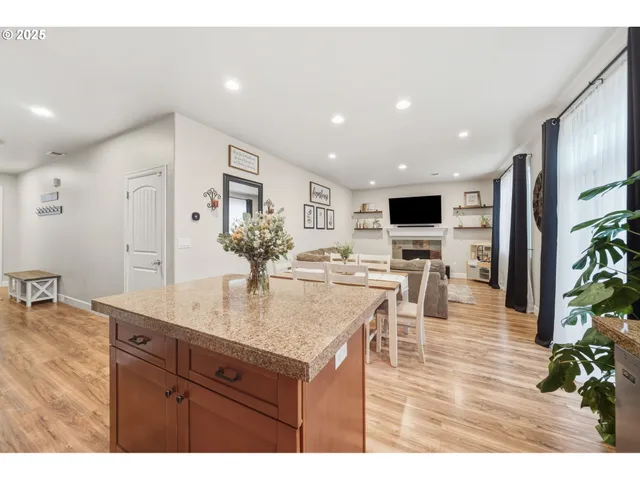 a view of living room kitchen with furniture and wooden floor