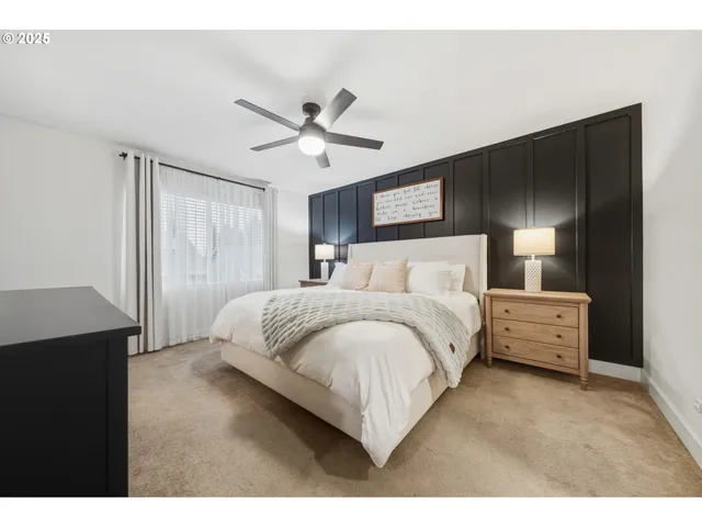 a spacious bedroom with a bed and a chandelier