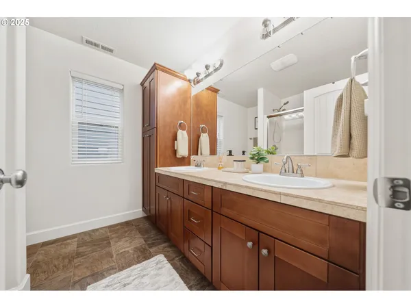 a bathroom with a sink a mirror and a vanity