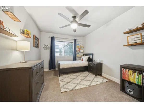 a living room with a bed and a flat screen tv
