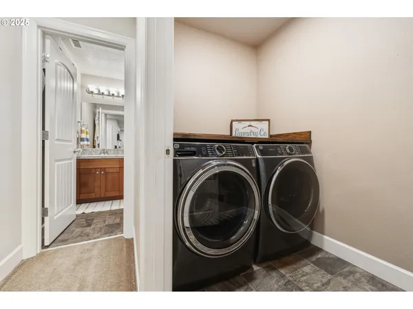 a view of a hallway with washer and dryer