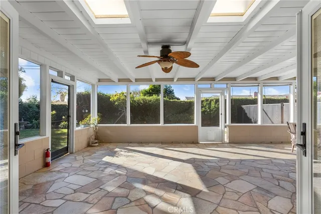 a living room filled with furniture and floor to ceiling window