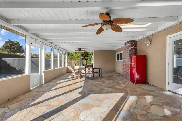 a living room with furniture ceiling fan and a rug