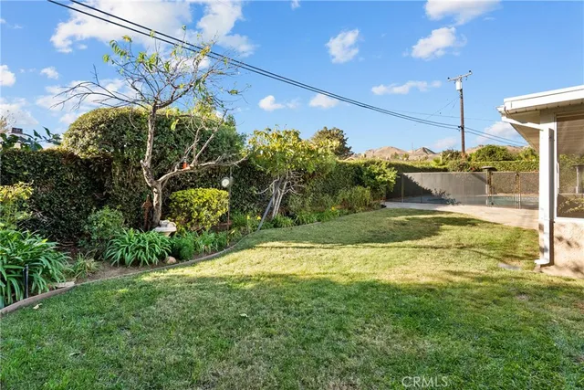 a view of a house with a yard and plants