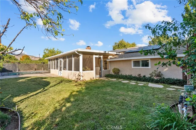 a backyard of a house with table and chairs