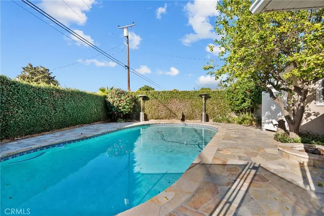 a view of a swimming pool with a yard