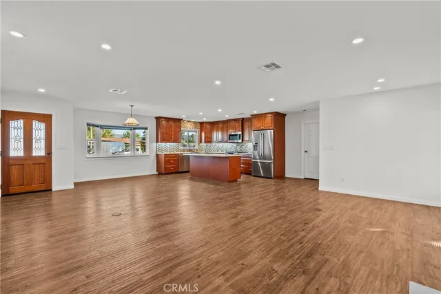 a view of a kitchen with a sink and a refrigerator