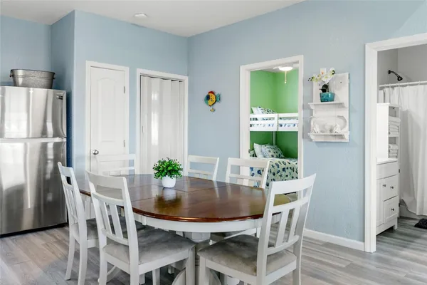 a view of a dining room with furniture and a potted plant
