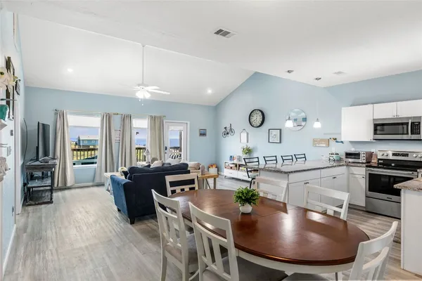 a large kitchen with a table and chairs