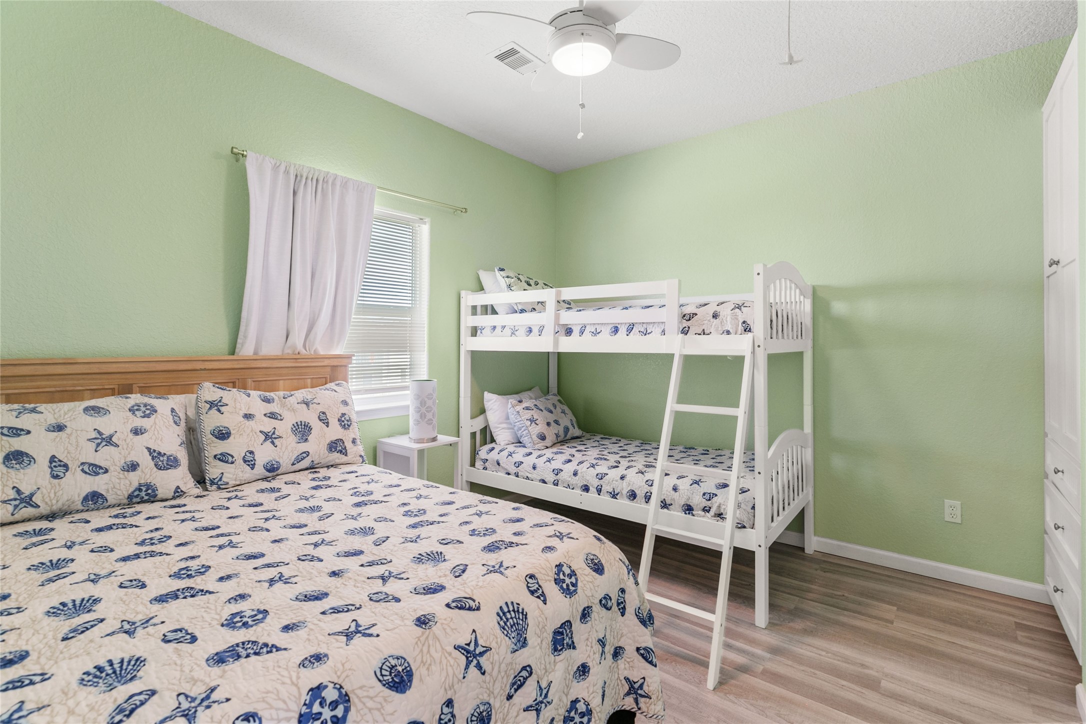 124 Howard Avenue, Unit A Surfside Beach, TX 77541 - Photo 19 of 36 a bedroom with a bed and a chair
