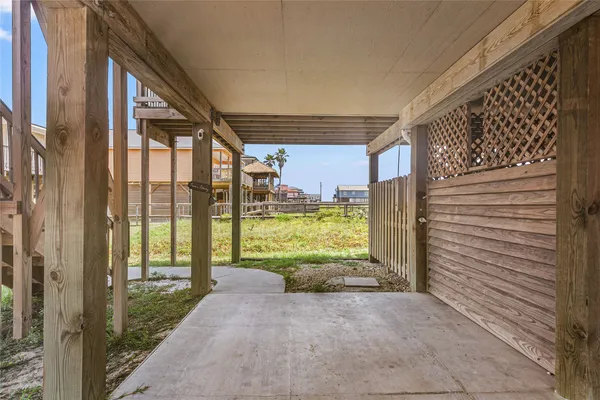 a view of a porch with wooden floor and roof
