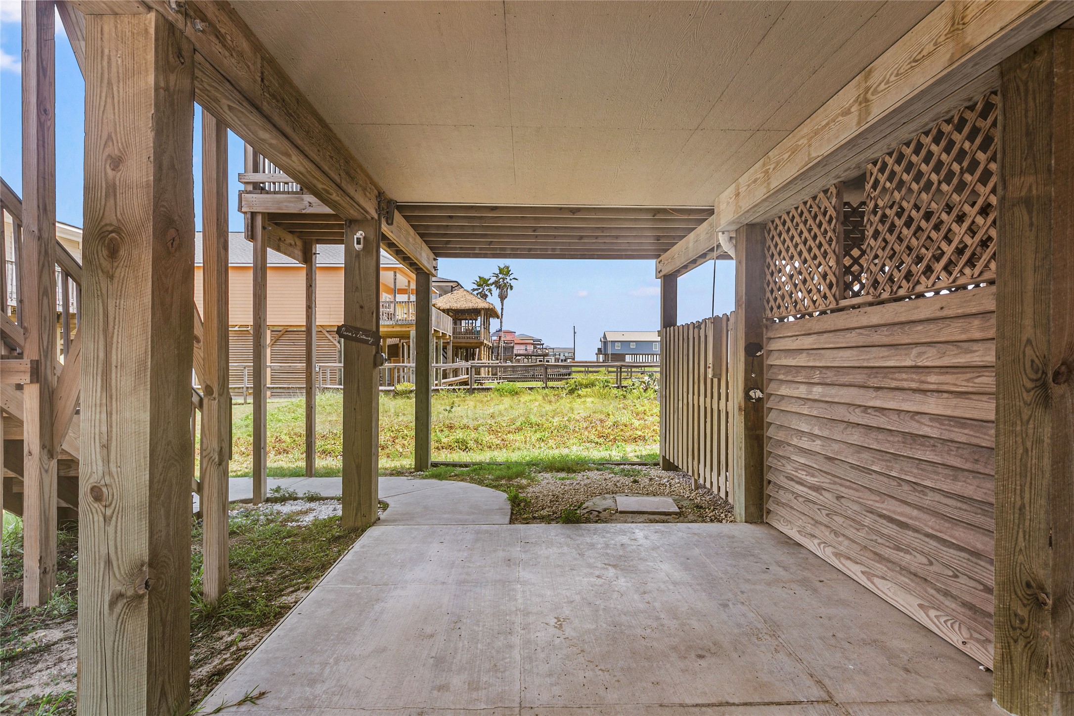 124 Howard Avenue, Unit A Surfside Beach, TX 77541 - Photo 23 of 36 a view of a porch with wooden floor and roof
