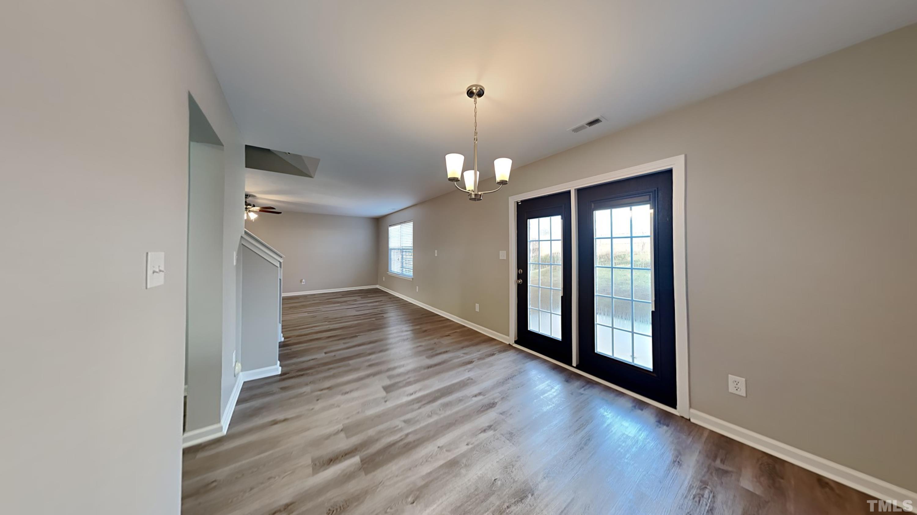 4105 Springfield Creek Drive Raleigh, NC 27616 - Photo 3 of 12 wooden floor in an empty room with a window
