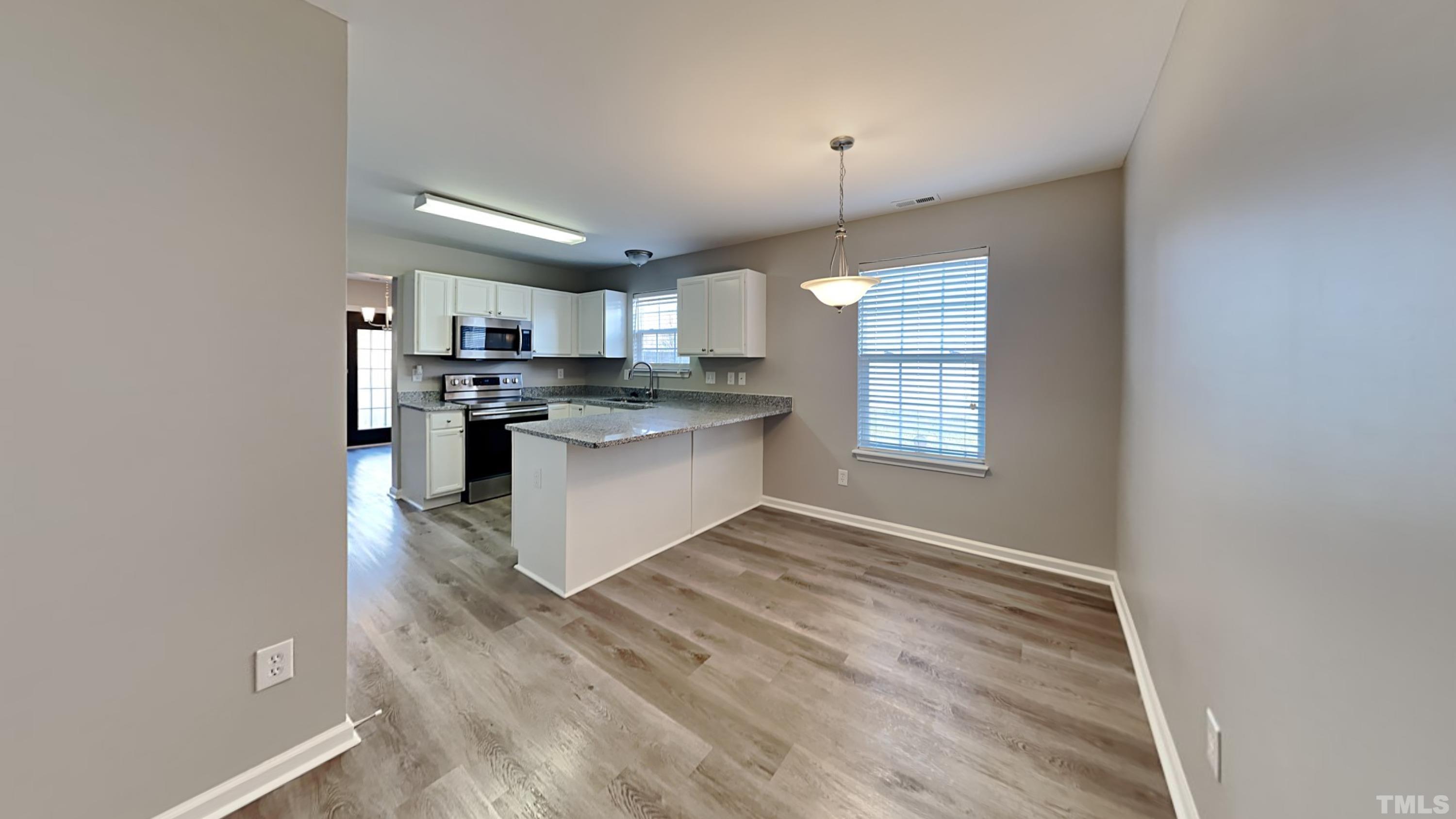 4105 Springfield Creek Drive Raleigh, NC 27616 - Photo 5 of 12 a view of kitchen with granite countertop cabinets and window