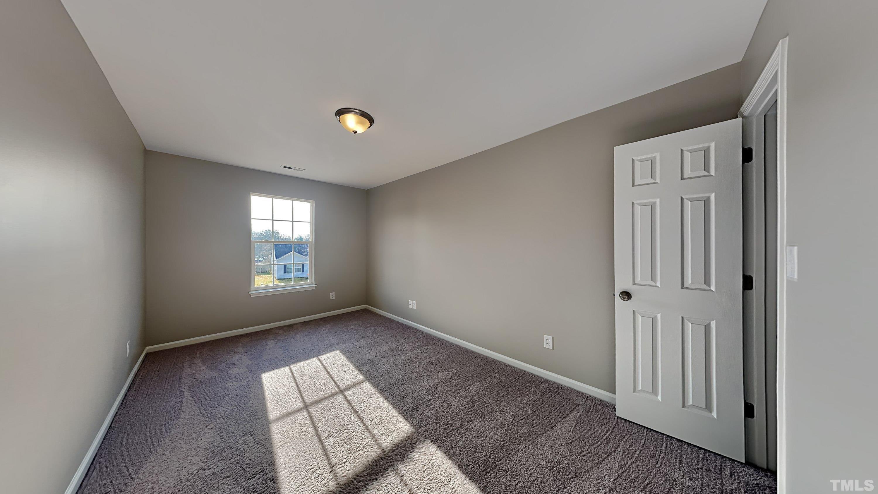 4105 Springfield Creek Drive Raleigh, NC 27616 - Photo 9 of 12 a view of an empty room and a window