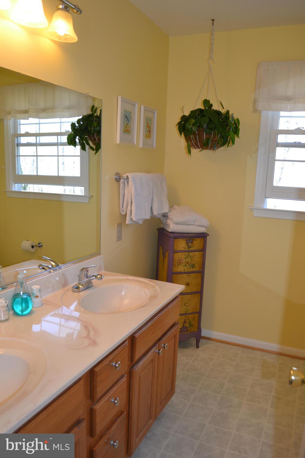 5901 Moore Road Marshall, VA 20115 - Photo 16 of 30 a bedroom with a bed and a chandelier