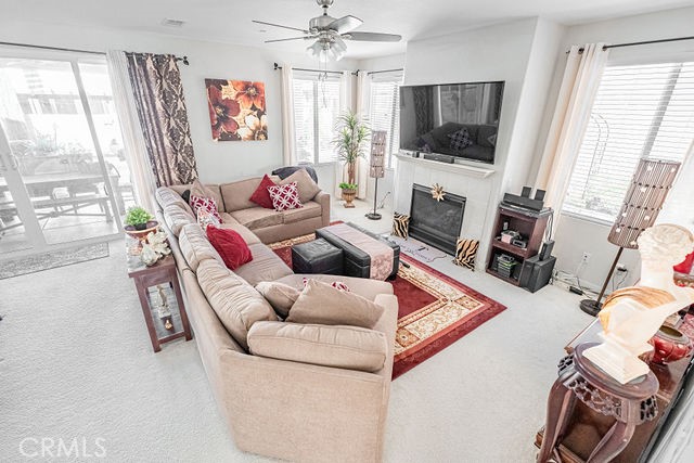 39580 Strada Pozzo Lake Elsinore, CA 92532 - Photo 14 of 67 a living room with furniture a flat screen tv and a fireplace