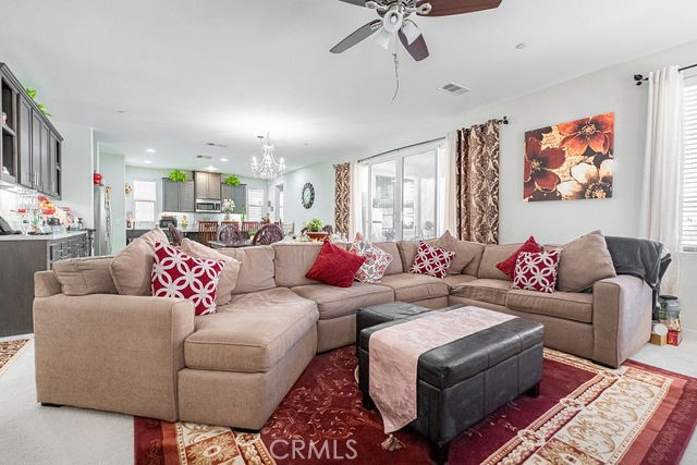 39580 Strada Pozzo Lake Elsinore, CA 92532 - Photo 15 of 67 a living room with furniture and a chandelier