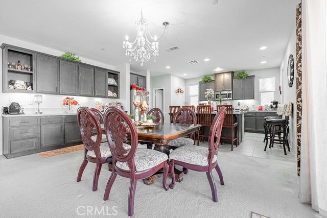 39580 Strada Pozzo Lake Elsinore, CA 92532 - Photo 17 of 67 a view of a dining area with furniture and chandelier