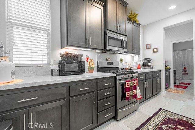39580 Strada Pozzo Lake Elsinore, CA 92532 - Photo 22 of 67 a kitchen with stainless steel appliances granite countertop a sink stove and cabinets