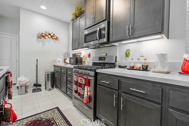 39580 Strada Pozzo Lake Elsinore, CA 92532 - Photo 23 of 67 a kitchen with stainless steel appliances granite countertop a sink stove and cabinets