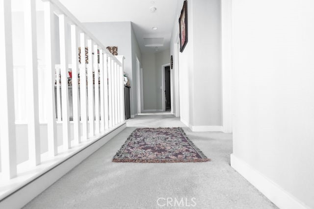 39580 Strada Pozzo Lake Elsinore, CA 92532 - Photo 26 of 67 a view of a hallway with wooden floor and a window