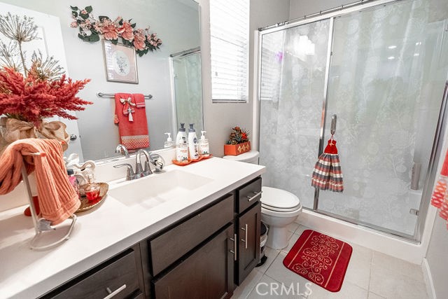 39580 Strada Pozzo Lake Elsinore, CA 92532 - Photo 34 of 67 a bathroom with a sink a toilet and shower curtain