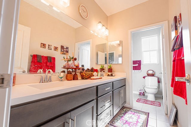 39580 Strada Pozzo Lake Elsinore, CA 92532 - Photo 35 of 67 a bathroom with a sink mirror and vanity