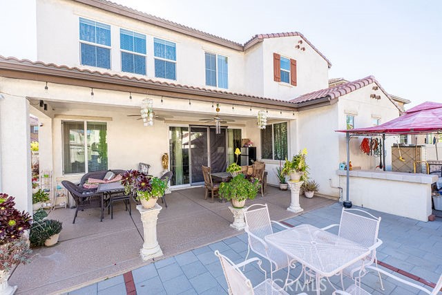 39580 Strada Pozzo Lake Elsinore, CA 92532 - Photo 56 of 67 a view of a patio with couches table and chairs and potted plants