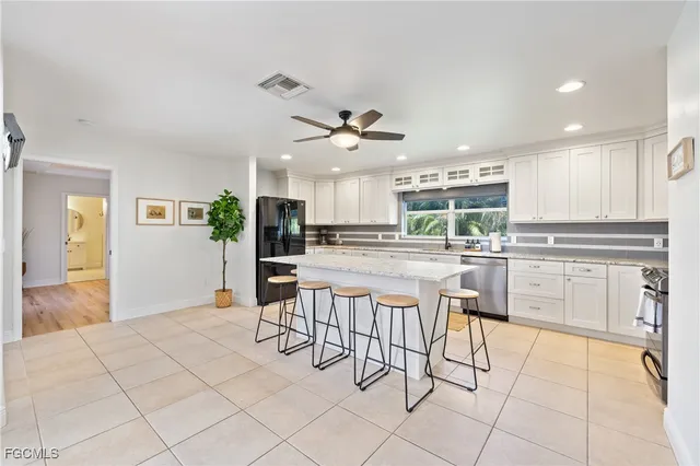 a kitchen with cabinets a sink and appliances