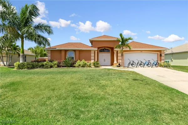 a front view of house with yard and green space