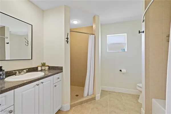 a bathroom with a bathtub shower and toilet