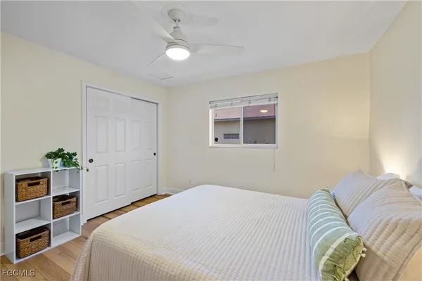 a bedroom with a bed and a window