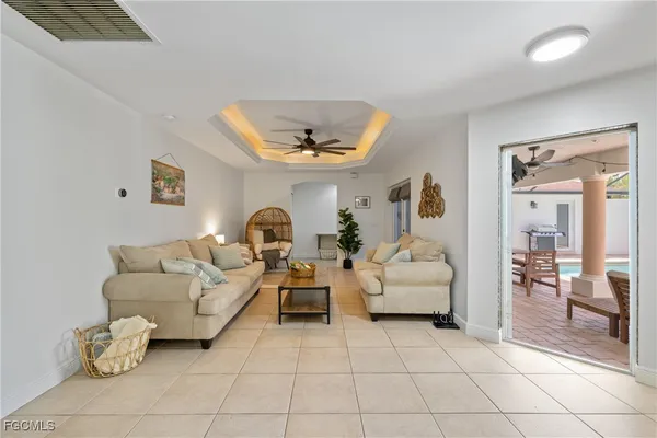 a living room with furniture and a chandelier