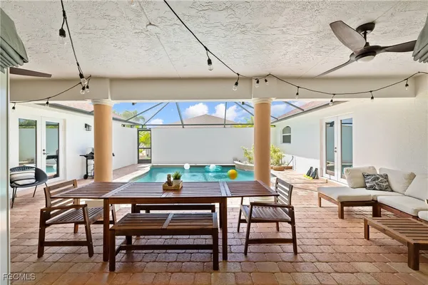 a view of a patio with a table and chairs