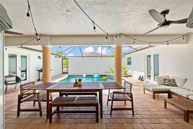 a view of a patio with a table and chairs