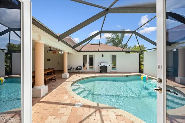 a bedroom with a bed and a view of kitchen