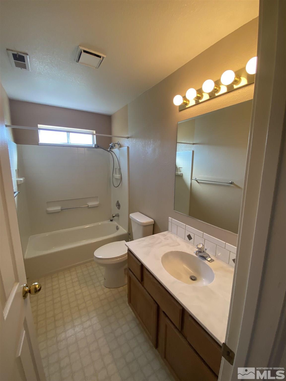 3380 Adler Court Reno, NV 89503 - Photo 15 of 30 a bathroom with a double vanity sink toilet mirror and shower