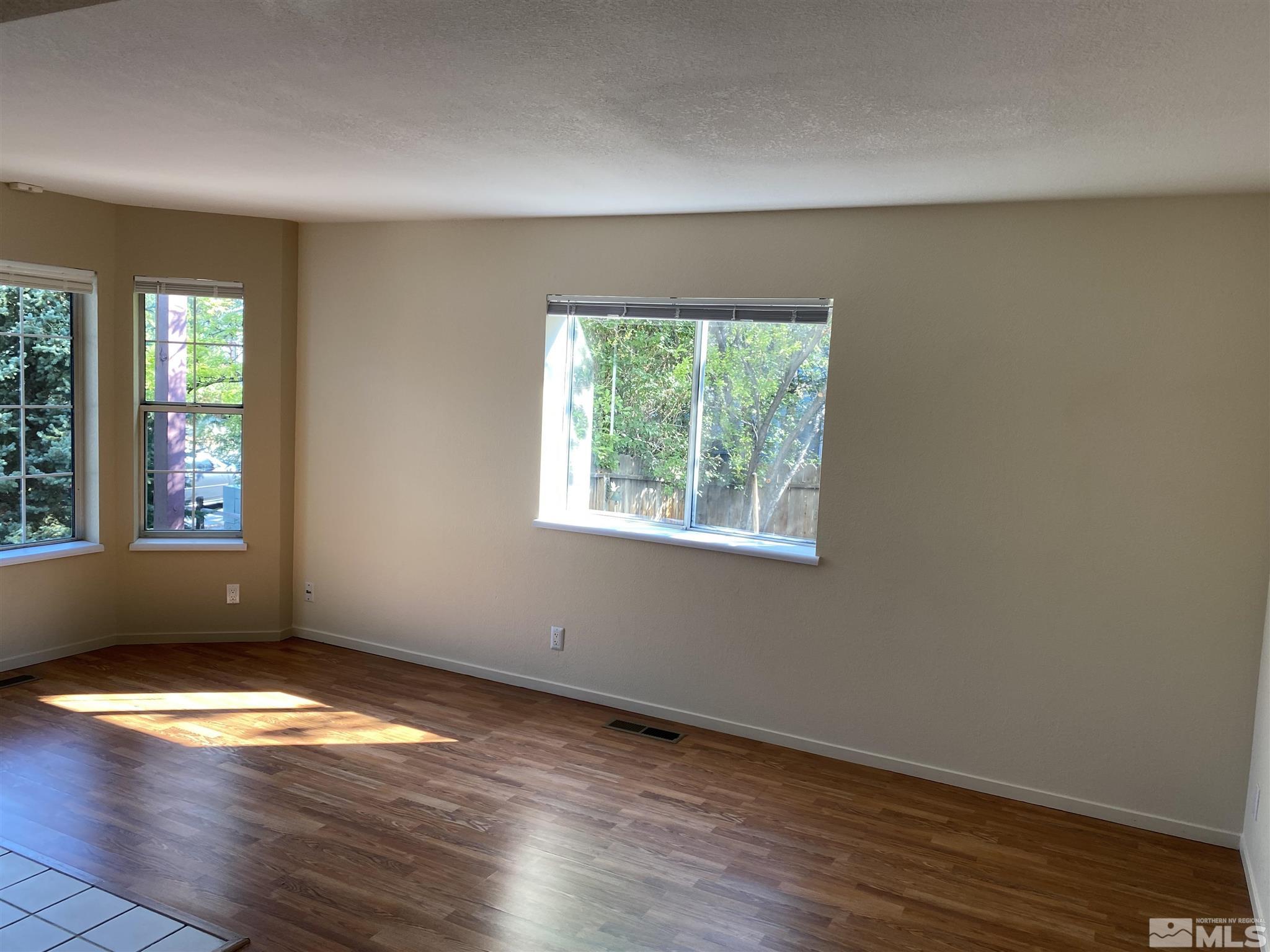 3380 Adler Court Reno, NV 89503 - Photo 2 of 30 an empty room with wooden floor and windows