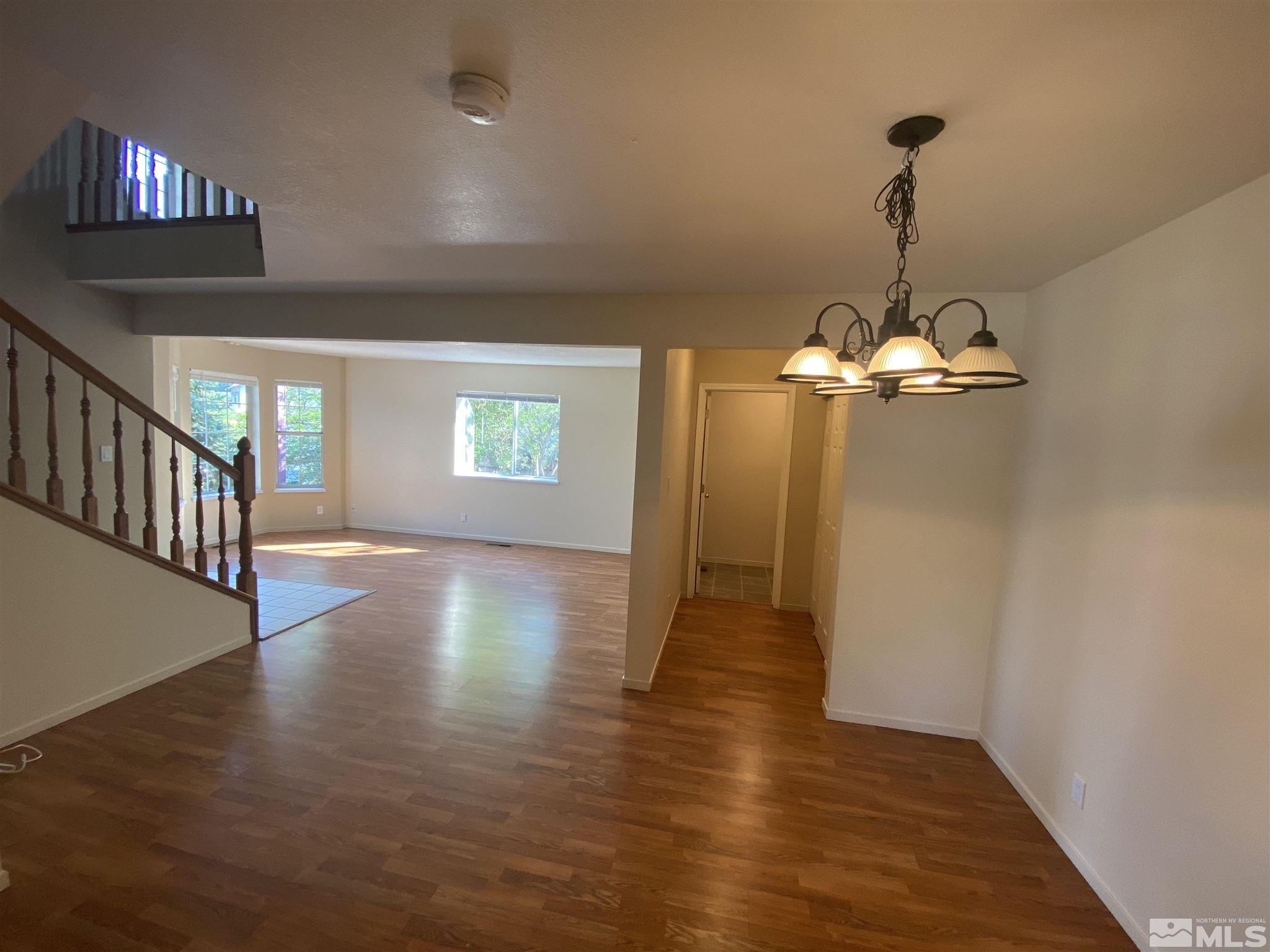 3380 Adler Court Reno, NV 89503 - Photo 3 of 30 a view of a room with wooden floor chandelier and windows