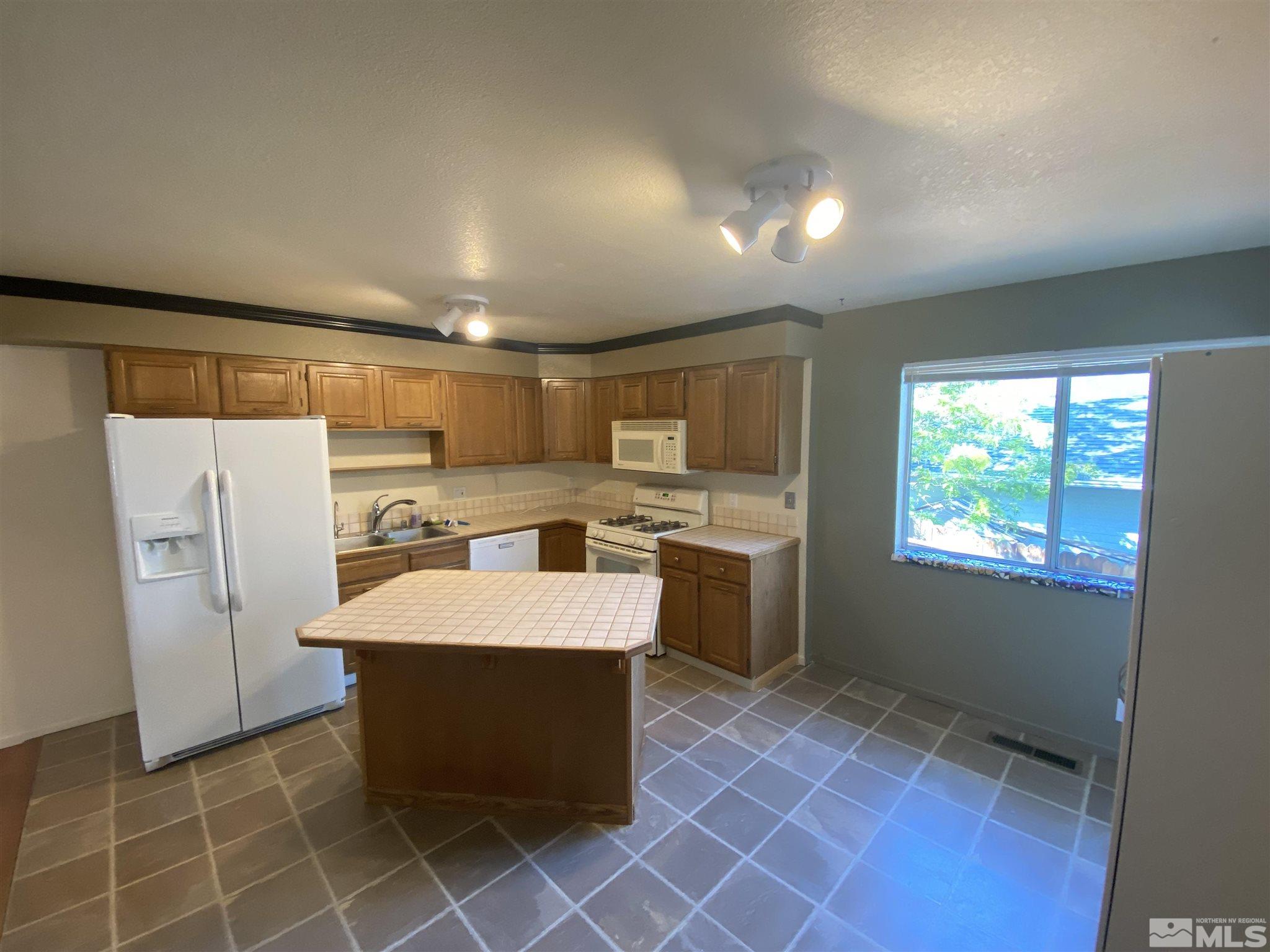 3380 Adler Court Reno, NV 89503 - Photo 4 of 30 a large kitchen with a large counter top appliances and cabinets