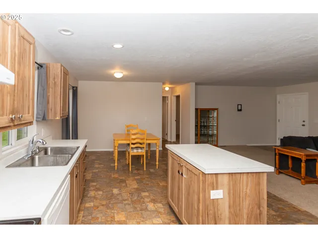 a living room with furniture and a book shelf