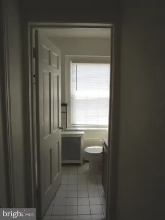 a bathroom with a toilet a sink and a window