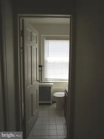 a bathroom with a toilet a sink and a window