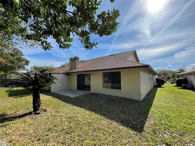 a front view of house with yard and trees